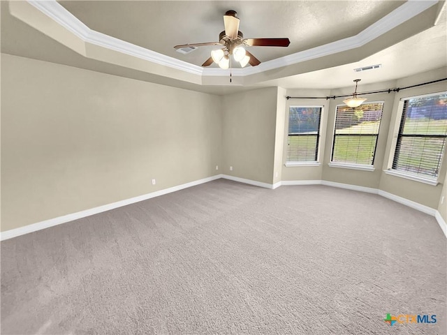 unfurnished room featuring carpet flooring, ceiling fan, crown molding, and a tray ceiling