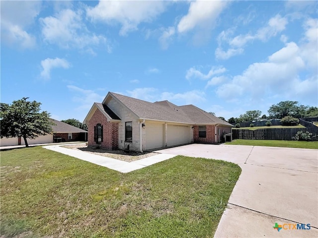 view of front of home with a garage and a front lawn