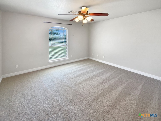 carpeted spare room featuring ceiling fan