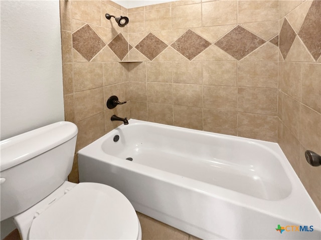 bathroom with tiled shower / bath combo and toilet