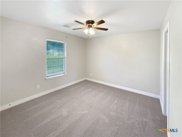 empty room featuring carpet flooring and ceiling fan