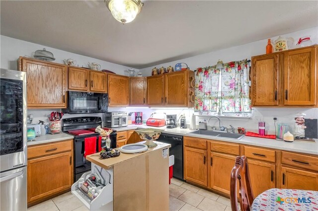 3302 Southhill Dr, Killeen, TX 76549 - kitchen featuring black appliances, a sink, light countertops, and light tile patterned floors