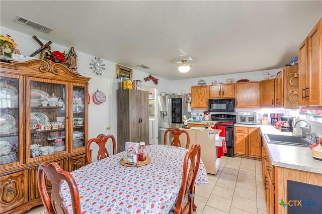 3302 Southhill Dr, Killeen, TX 76549 - kitchen with black microwave, a sink, range, stainless steel refrigerator with ice dispenser, and light countertops