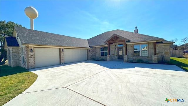 view of front of home with a garage and a front yard