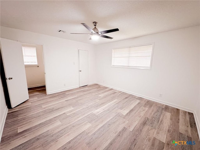 unfurnished room with ceiling fan and light hardwood / wood-style floors