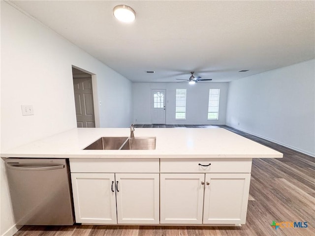 kitchen with white cabinets, dishwasher, kitchen peninsula, and sink