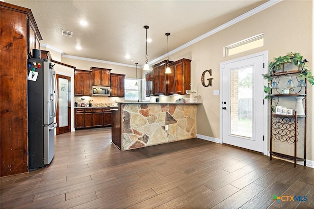 kitchen featuring hanging light fixtures, dark hardwood / wood-style floors, kitchen peninsula, and appliances with stainless steel finishes