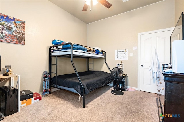 carpeted bedroom with vaulted ceiling and ceiling fan