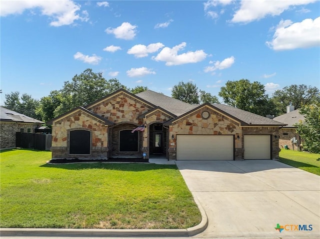 view of front of house with a garage and a front lawn