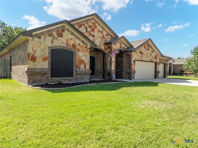 view of front of home featuring a garage and a front lawn