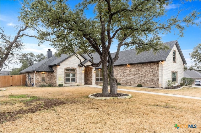 french provincial home featuring a front yard