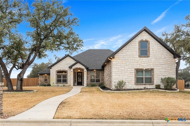 french country style house with a front lawn