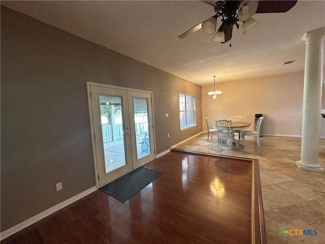 449 Rosehall Ln, Temple, TX 76504 - unfurnished dining area with decorative columns, french doors, a ceiling fan, wood finished floors, and a chandelier