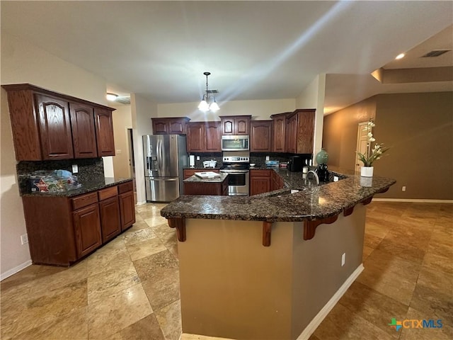 449 Rosehall Ln, Temple, TX 76504 - kitchen featuring stainless steel appliances, backsplash, a peninsula, a kitchen breakfast bar, and dark stone counters