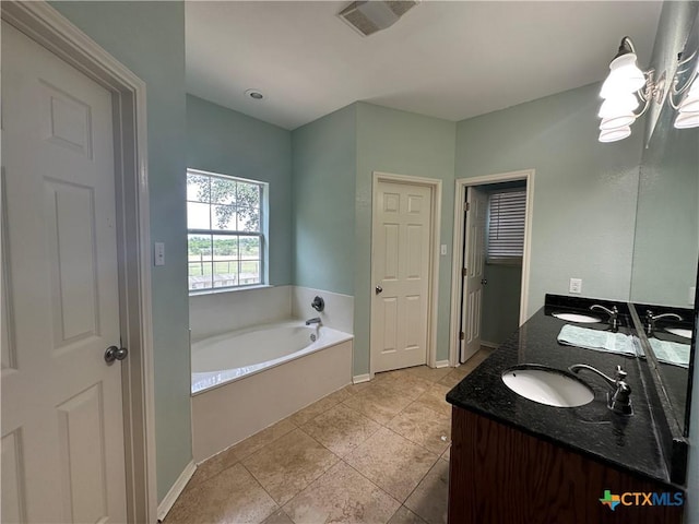449 Rosehall Ln, Temple, TX 76504 - bathroom with double vanity, a bath, a chandelier, and tile patterned floors