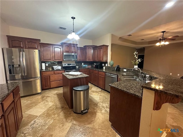 449 Rosehall Ln, Temple, TX 76504 - kitchen with stainless steel appliances, a peninsula, decorative backsplash, ceiling fan, and dark stone counters
