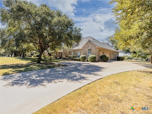 view of front of house with a garage and a front lawn