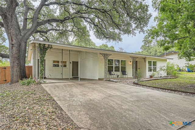 ranch-style house featuring a carport