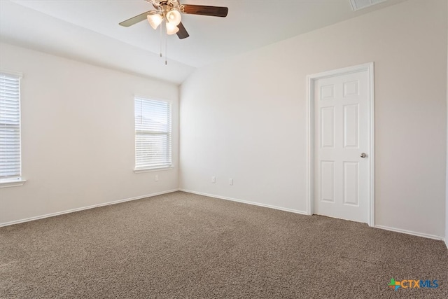 carpeted spare room featuring lofted ceiling and ceiling fan