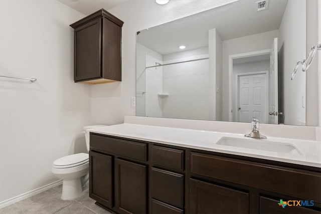 bathroom featuring vanity, tile patterned floors, toilet, and a shower