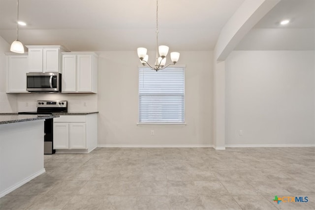 kitchen featuring hanging light fixtures, white cabinetry, an inviting chandelier, and appliances with stainless steel finishes