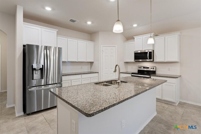 kitchen featuring a center island with sink, white cabinetry, sink, and appliances with stainless steel finishes