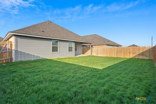 back of house featuring a yard