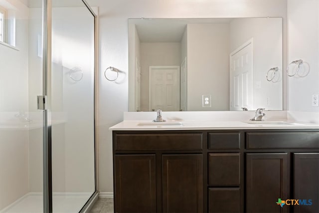 bathroom with tile patterned flooring, an enclosed shower, and vanity