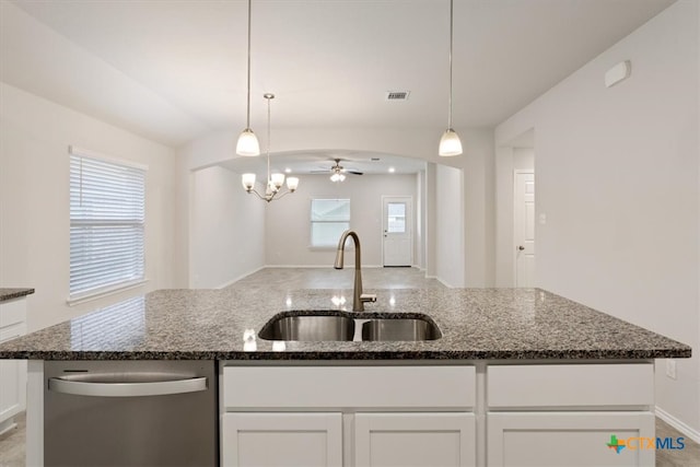 kitchen featuring dishwasher, white cabinetry, dark stone counters, and sink