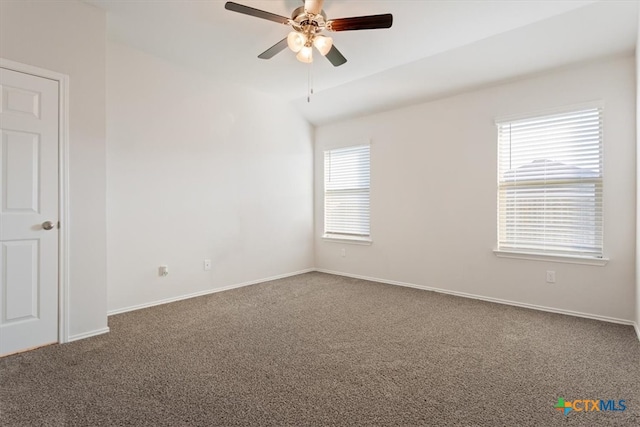 empty room featuring carpet, a healthy amount of sunlight, and ceiling fan