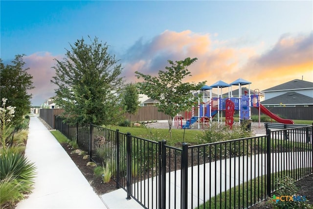 playground at dusk featuring fence and playground community