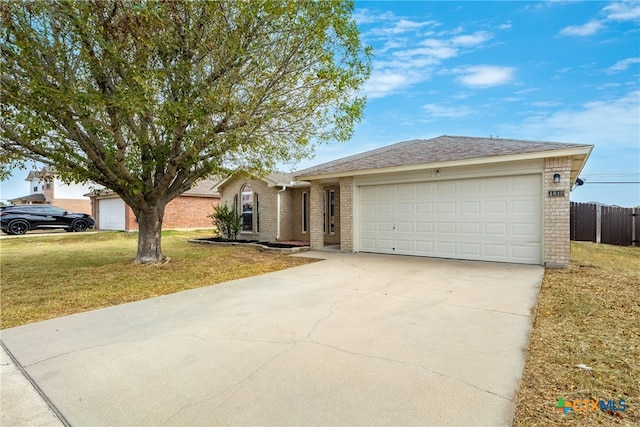 ranch-style home with a garage and a front lawn