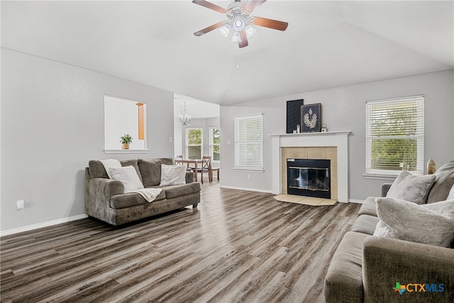 living room with a fireplace, hardwood / wood-style floors, vaulted ceiling, and plenty of natural light