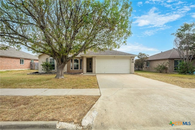 single story home with a garage and a front yard