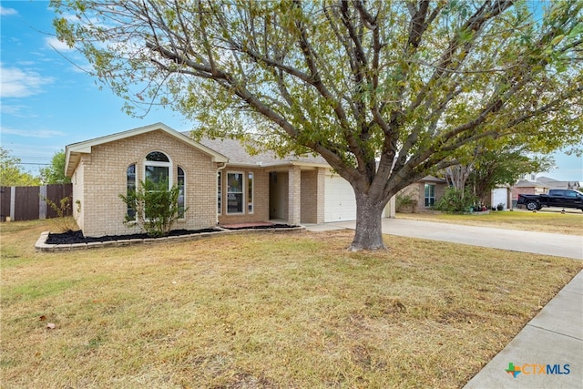 single story home featuring a garage and a front lawn