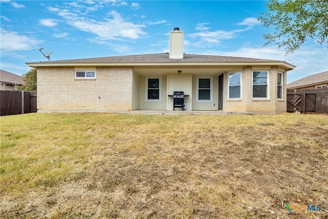 back of house with a yard