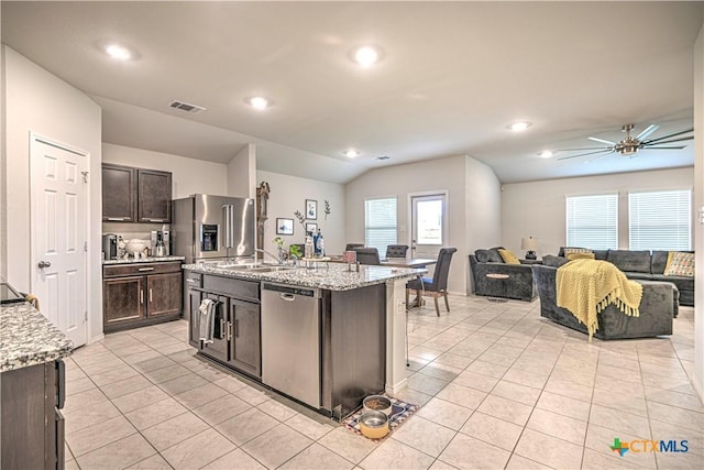 4001 Arafel Ln, Killeen, TX 76542 - kitchen featuring open floor plan, dark brown cabinetry, stainless steel appliances, and light tile patterned floors