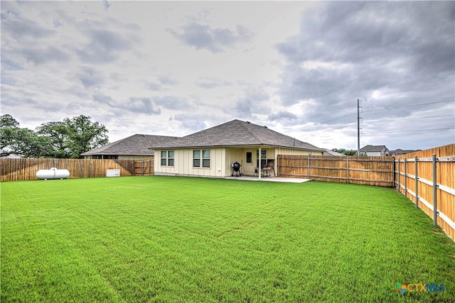 4001 Arafel Ln, Killeen, TX 76542 - back of property featuring a yard, a patio, a shingled roof, and a fenced backyard