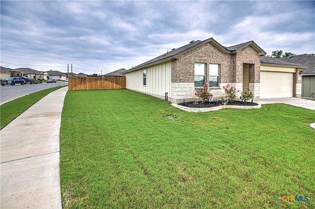 4001 Arafel Ln, Killeen, TX 76542 - view of front of property with concrete driveway, fence, a garage, board and batten siding, and a front yard
