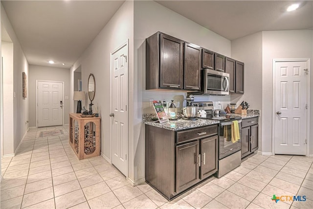 4001 Arafel Ln, Killeen, TX 76542 - kitchen with light stone countertops, dark brown cabinets, stainless steel appliances, and light tile patterned floors