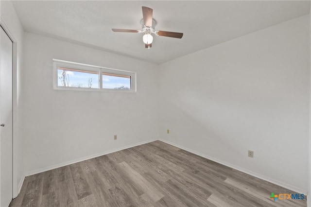 unfurnished room featuring hardwood / wood-style flooring and ceiling fan