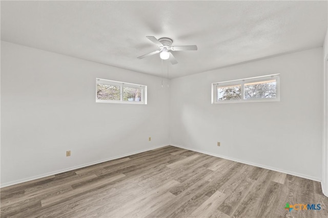 empty room featuring hardwood / wood-style flooring and ceiling fan