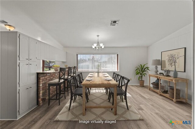 interior space with a chandelier and light hardwood / wood-style floors