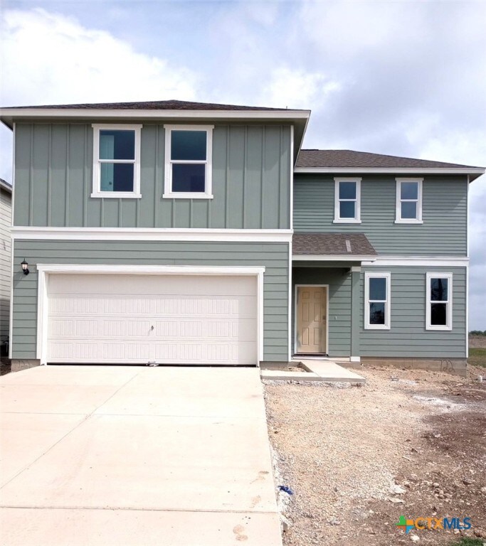 front facade featuring a front yard and a garage