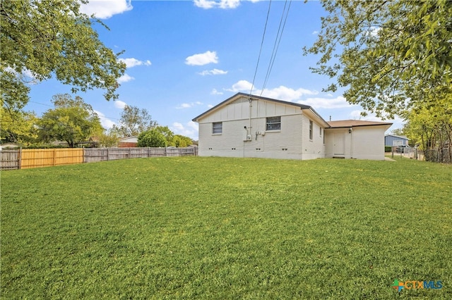 back of house with a yard