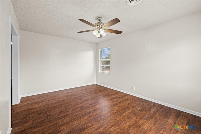 spare room with ceiling fan, a textured ceiling, and dark hardwood / wood-style floors