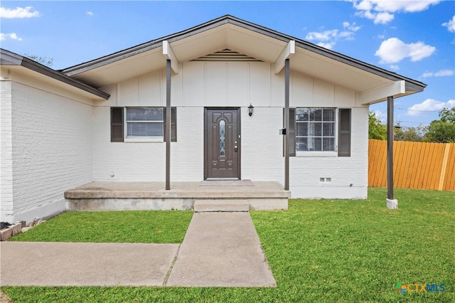 property entrance with a lawn