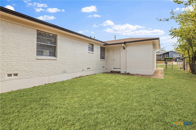 rear view of house featuring a lawn