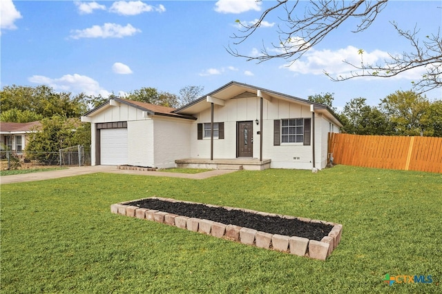 view of front of property featuring a garage and a front yard