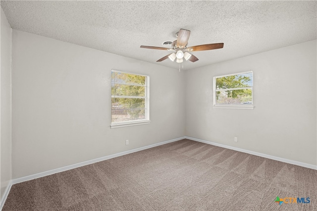 spare room with ceiling fan, a textured ceiling, and carpet